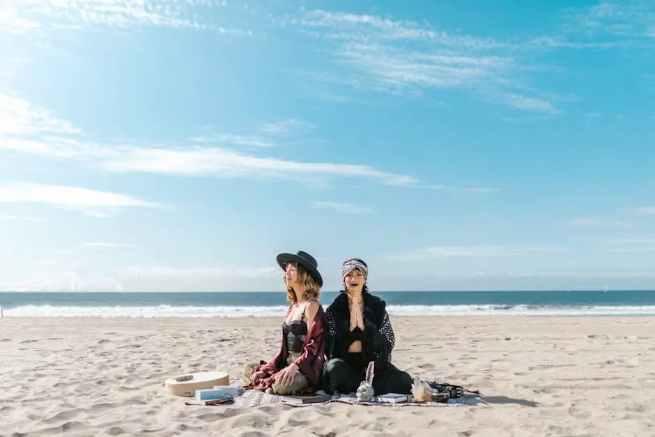 Two women meditating on a sunny beach